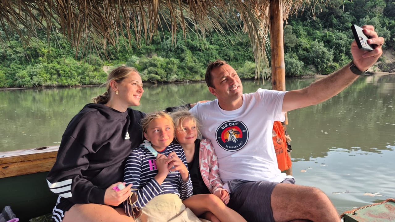 Family taking photos aboard the river barge